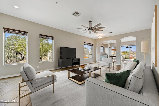 tiled living room with ceiling fan