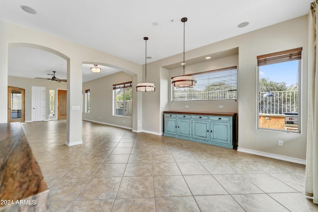 kitchen with light tile patterned floors, decorative light fixtures, and ceiling fan