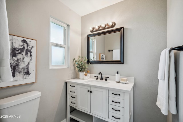 bathroom featuring toilet and vanity