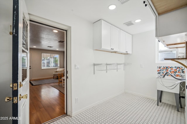 interior space featuring baseboards, visible vents, and recessed lighting