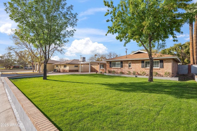 ranch-style home featuring brick siding and a front lawn