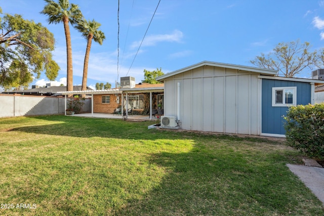 rear view of house featuring ac unit, a lawn, fence, and a patio