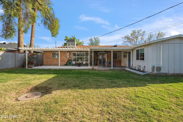 rear view of property featuring fence, a yard, a patio area, a pergola, and brick siding