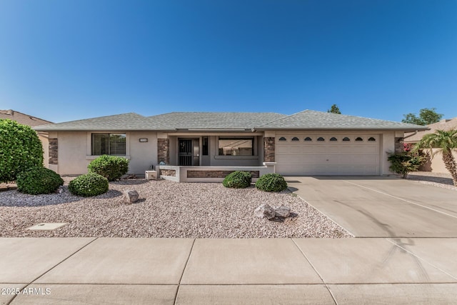 ranch-style house featuring a garage, stucco siding, and driveway