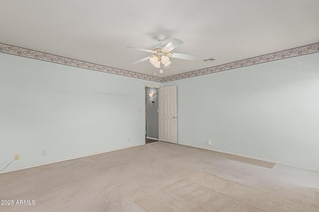 unfurnished room with a ceiling fan, baseboards, visible vents, and light carpet