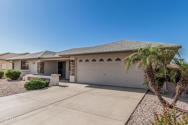 ranch-style house with a garage, stucco siding, driveway, and stone siding