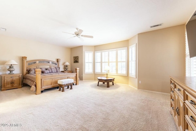 bedroom with baseboards, visible vents, a ceiling fan, and light colored carpet