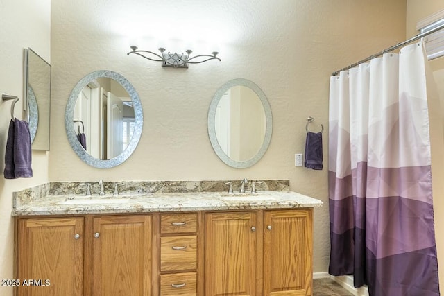 full bath featuring double vanity, a sink, and a shower with curtain