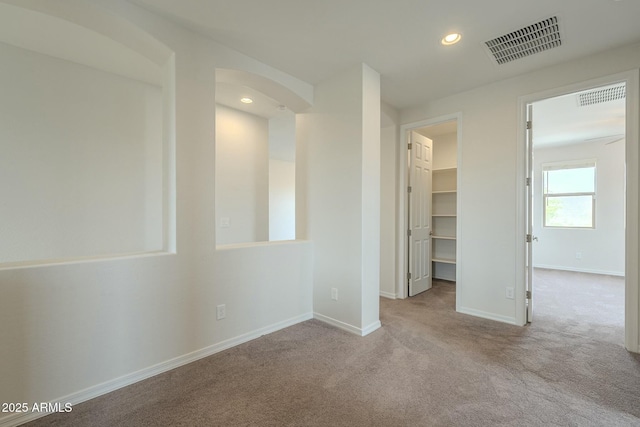 4090 E Bethena St, Gilbert, AZ 85295 - empty room with carpet flooring, visible vents, baseboards, recessed lighting, and arched walkways