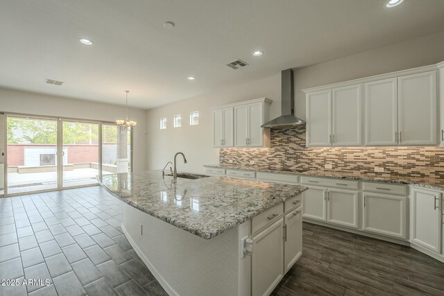 4090 E Bethena St, Gilbert, AZ 85295 - kitchen with wall chimney range hood, visible vents, decorative backsplash, and white cabinetry