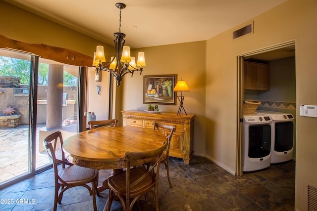 dining area with an inviting chandelier, baseboards, visible vents, and washing machine and clothes dryer