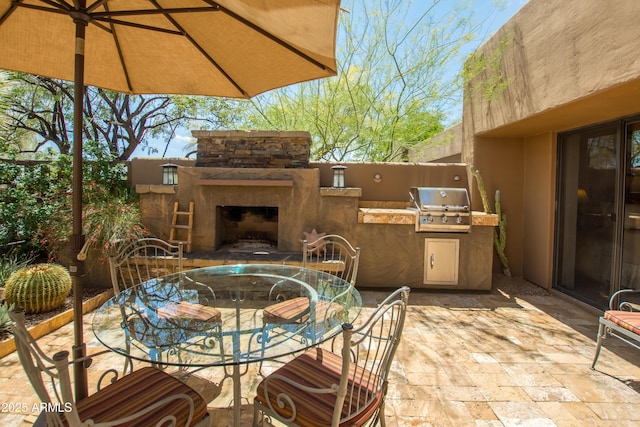 view of patio / terrace featuring grilling area, exterior kitchen, outdoor dining area, and an outdoor stone fireplace