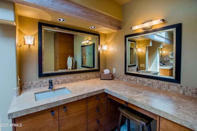 bathroom featuring vanity and decorative backsplash