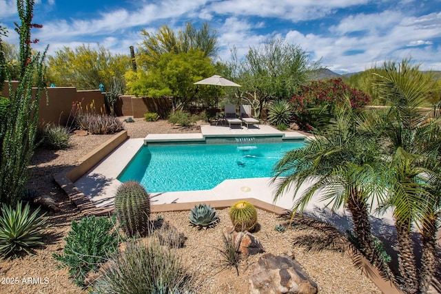view of swimming pool with a patio, a fenced in pool, and a fenced backyard