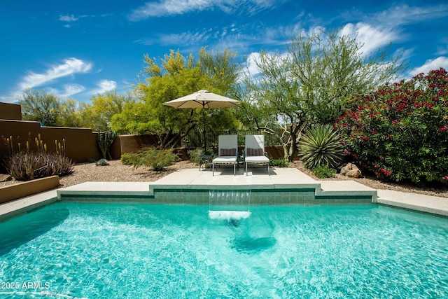 pool featuring a fenced backyard and a patio area