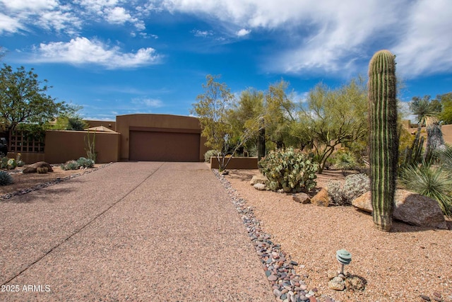 view of front of property featuring concrete driveway, stucco siding, and a garage