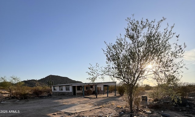 view of front of property with a patio area and a mountain view