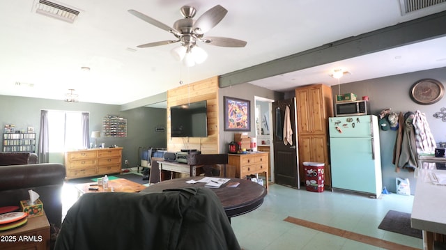 living room featuring visible vents and a ceiling fan