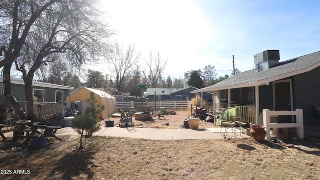 view of yard with cooling unit, a patio area, and fence