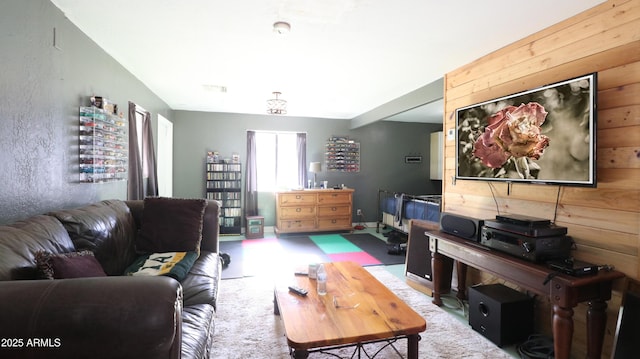 living area featuring wood walls and visible vents