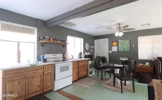 kitchen with white electric range oven, visible vents, brown cabinetry, light countertops, and a sink