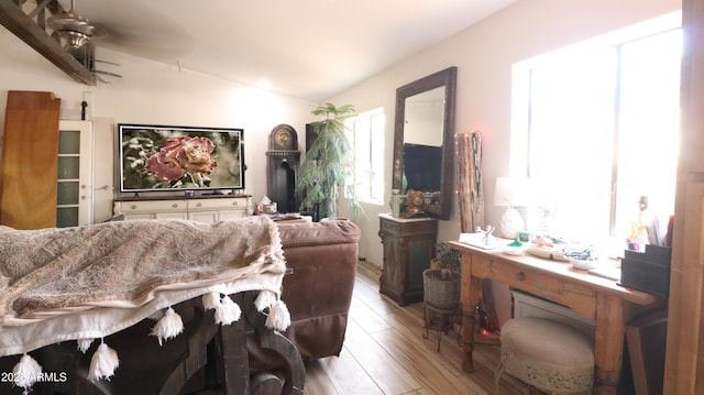 interior space with lofted ceiling, light wood finished floors, and ceiling fan