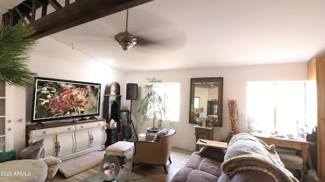 living area featuring vaulted ceiling with beams