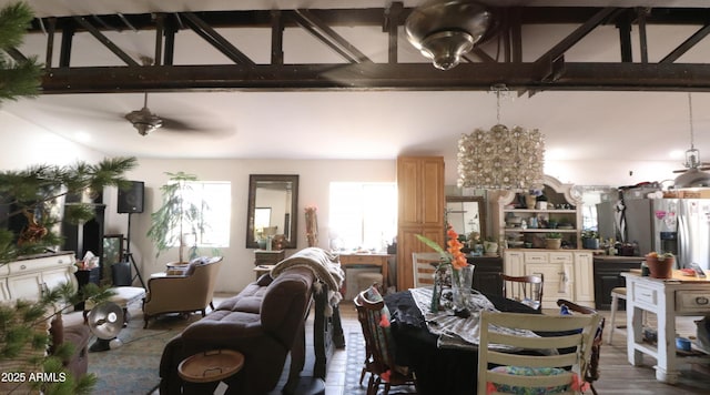 dining space with high vaulted ceiling, beam ceiling, and wood finished floors