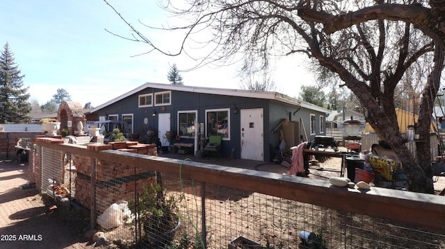 back of house featuring fence