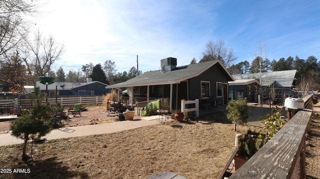 exterior space with fence and central AC