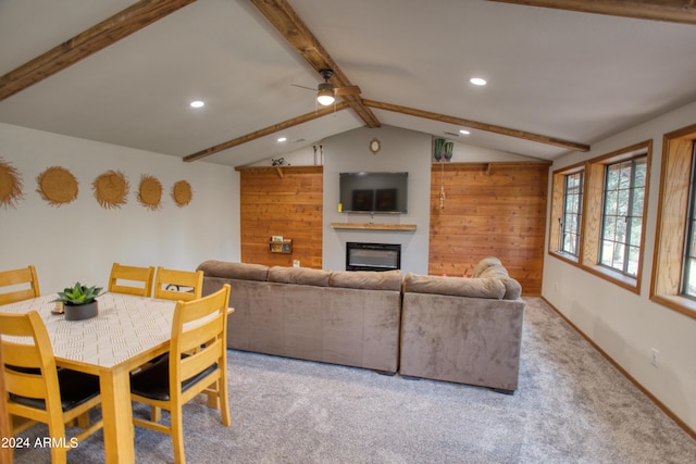 living room featuring ceiling fan, a glass covered fireplace, lofted ceiling with beams, and recessed lighting