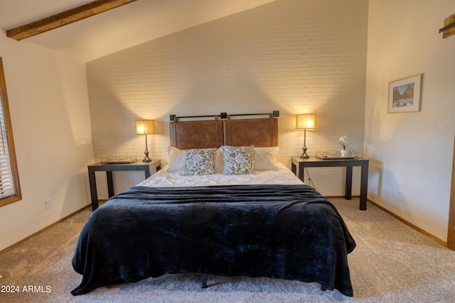 bedroom with carpet floors, beam ceiling, and baseboards