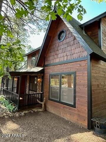 view of side of home with covered porch