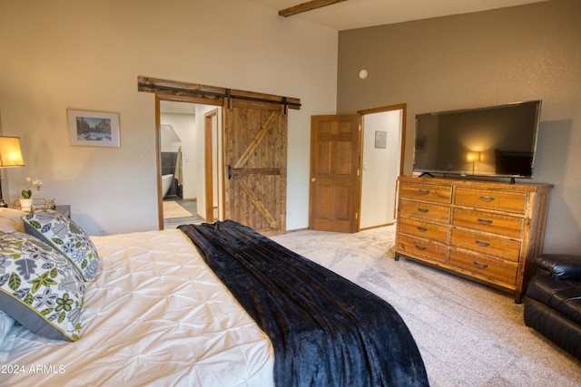 bedroom featuring a barn door, carpet, and high vaulted ceiling