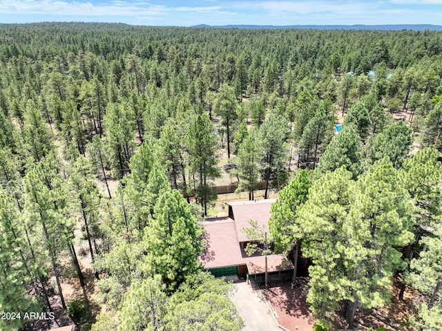 birds eye view of property featuring a view of trees