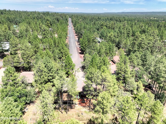 drone / aerial view featuring a wooded view