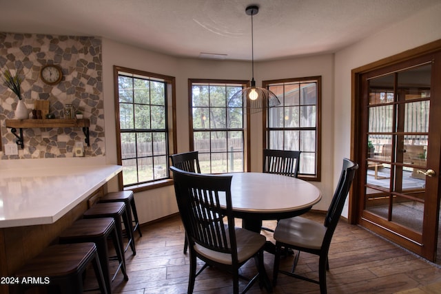 dining area with baseboards and dark wood-style flooring