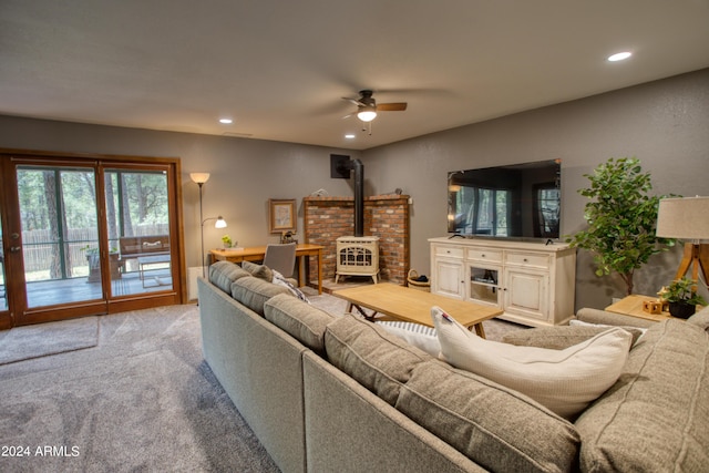 living room with a ceiling fan, carpet flooring, recessed lighting, and a wood stove