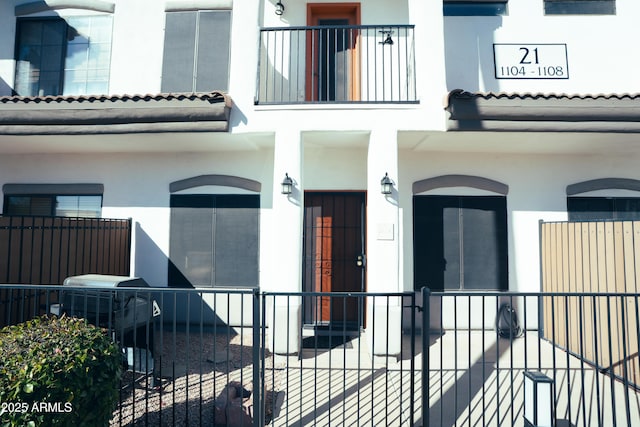 exterior space featuring fence and stucco siding