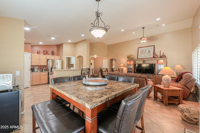 dining room with arched walkways and recessed lighting