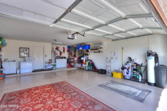 garage featuring water heater and a garage door opener