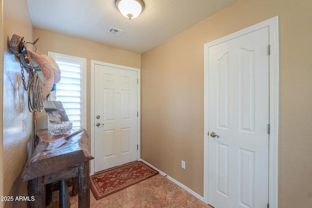 entrance foyer featuring baseboards and visible vents