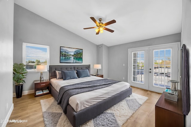 bedroom featuring access to outside, light wood-style floors, vaulted ceiling, multiple windows, and french doors
