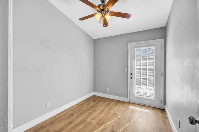 interior space featuring wood finished floors, baseboards, and a ceiling fan