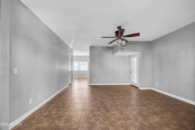 unfurnished living room with ceiling fan, baseboards, and visible vents