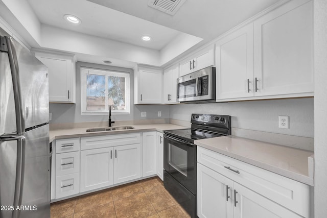 kitchen featuring a sink, visible vents, white cabinets, and appliances with stainless steel finishes