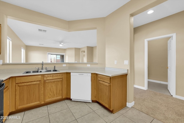 kitchen with sink, light colored carpet, range, ceiling fan, and white dishwasher