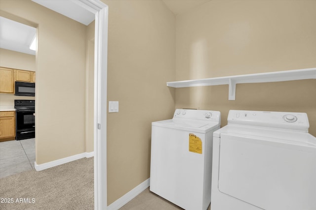 washroom featuring washing machine and clothes dryer and light colored carpet