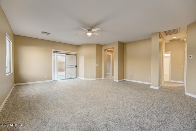 carpeted empty room with plenty of natural light and ceiling fan