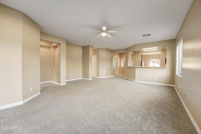 spare room with ceiling fan and carpet